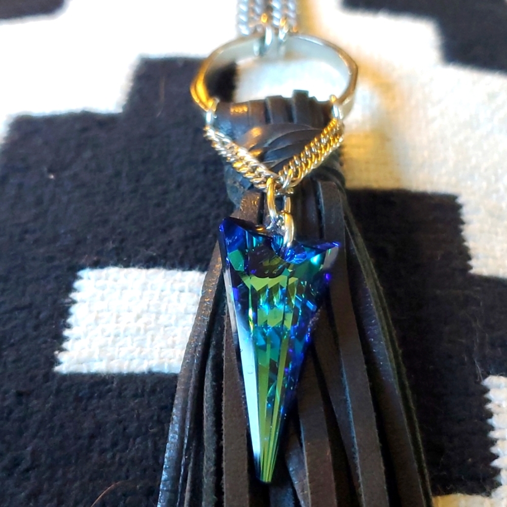 Statement necklace with leather tassel and iridescent glass pendant.